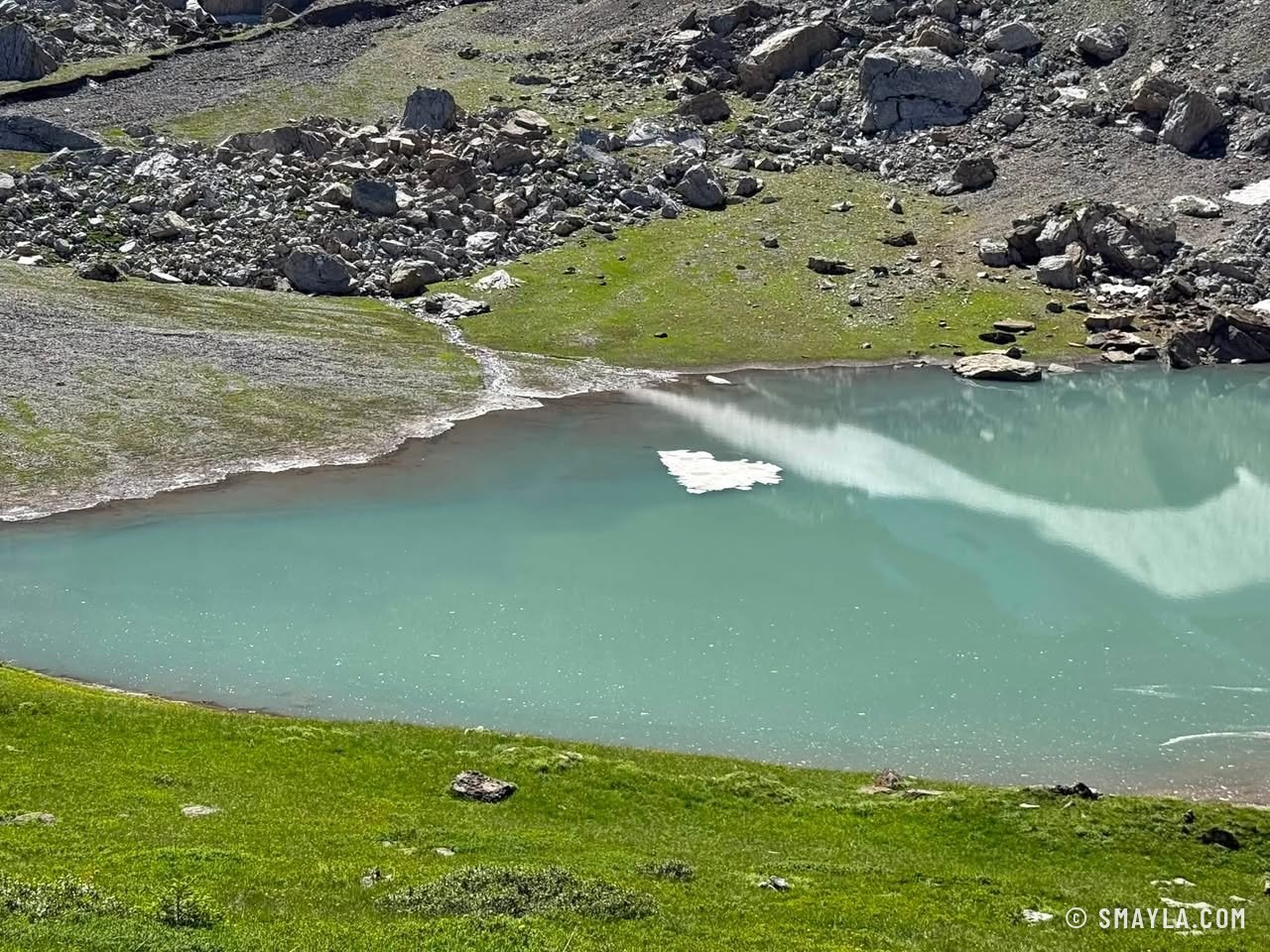 Pale green lake and snowfields