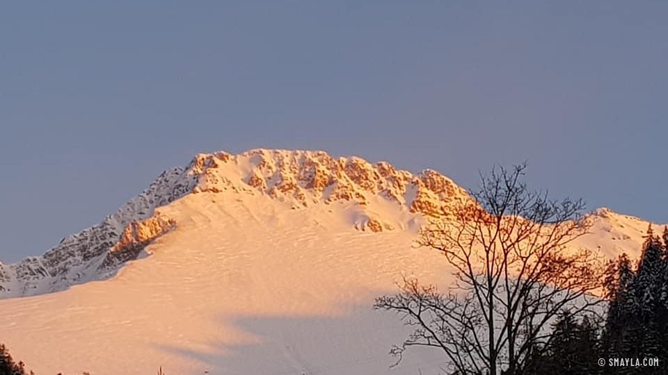 Snowy summit pink at sunset